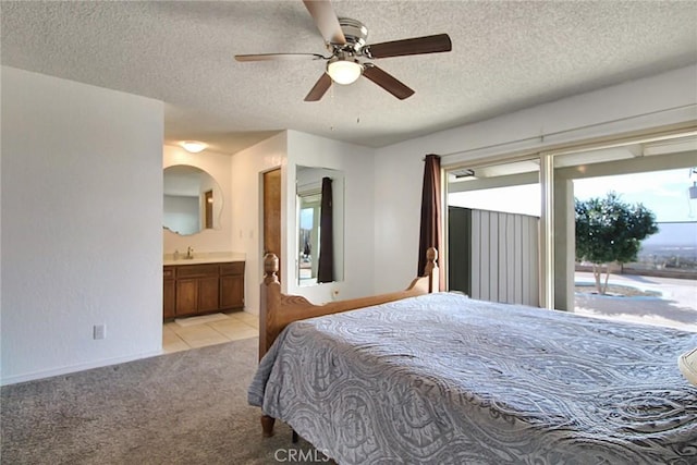 bedroom with sink, ceiling fan, connected bathroom, a textured ceiling, and light colored carpet