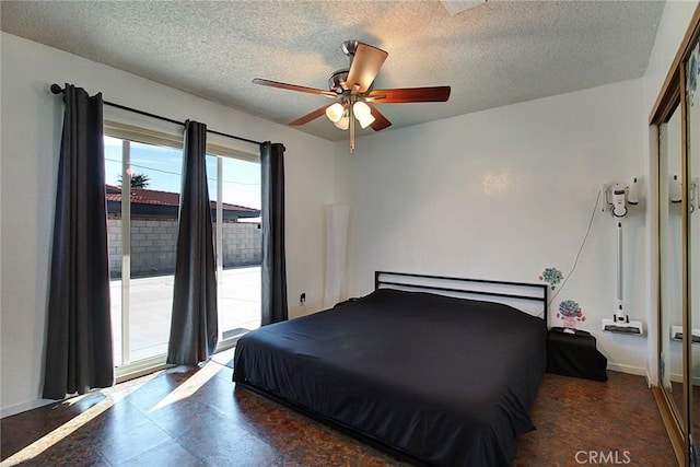 bedroom with ceiling fan, a closet, and a textured ceiling