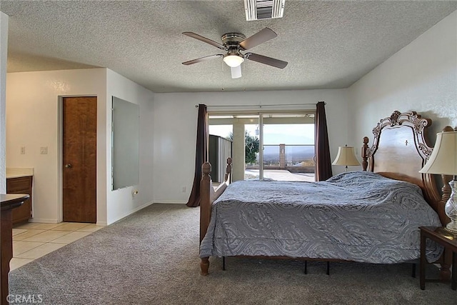 carpeted bedroom with ceiling fan, access to exterior, and a textured ceiling