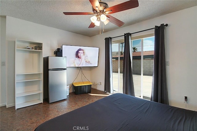 unfurnished bedroom with ceiling fan, stainless steel fridge, and a textured ceiling