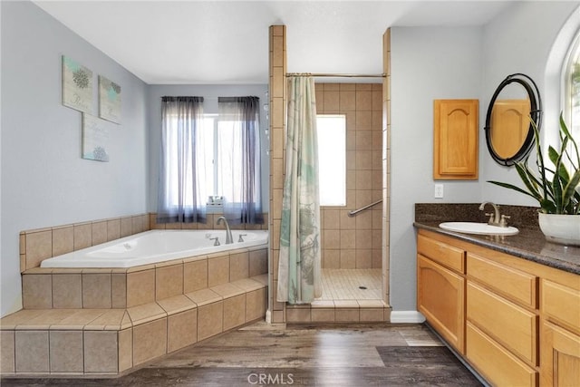 bathroom featuring vanity, hardwood / wood-style floors, and shower with separate bathtub