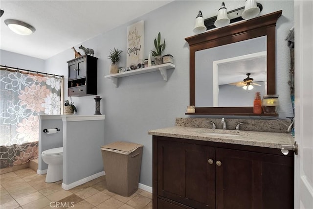 full bathroom with ceiling fan, vanity, tile patterned floors, toilet, and shower / bath combo with shower curtain