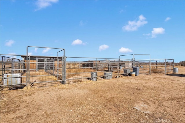 view of yard with a rural view and an outdoor structure