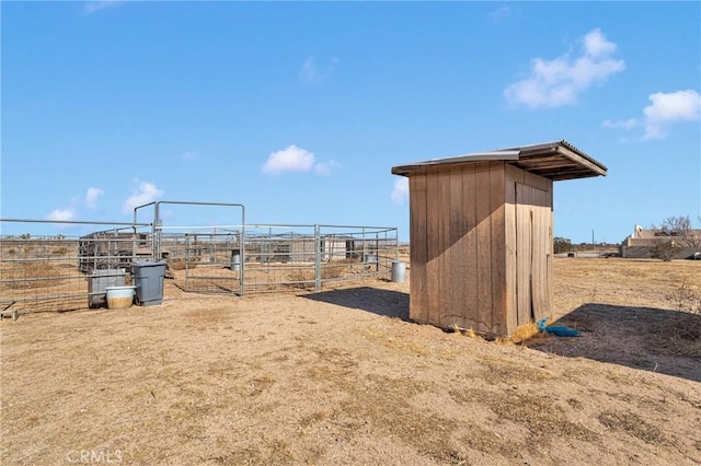 view of yard featuring an outbuilding and a rural view