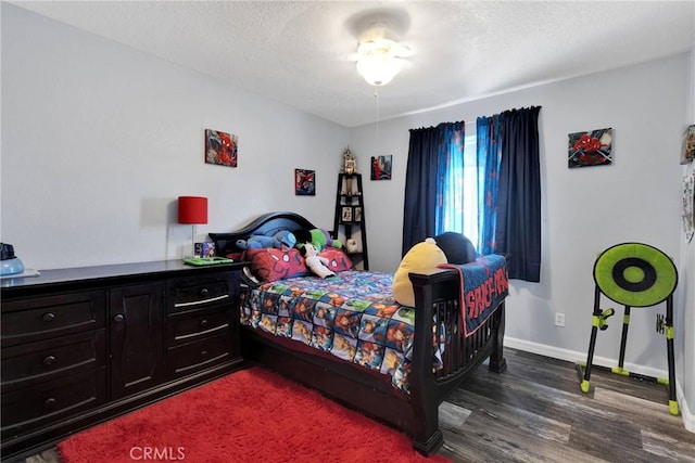 bedroom featuring dark hardwood / wood-style floors and a textured ceiling