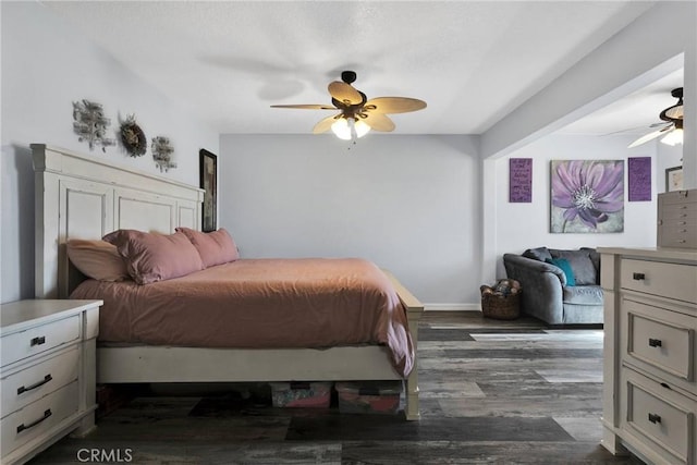 bedroom with ceiling fan and dark hardwood / wood-style flooring