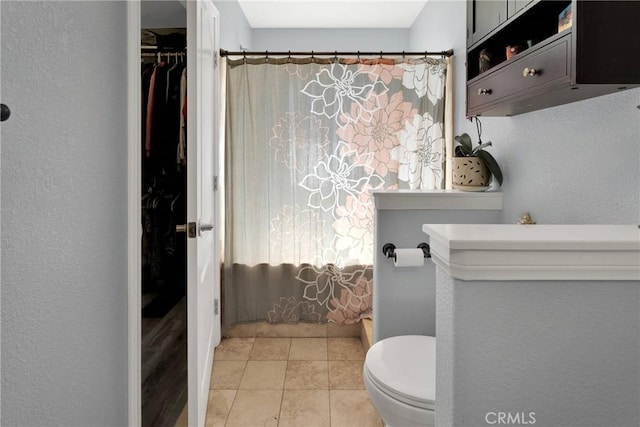 bathroom featuring tile patterned floors and toilet