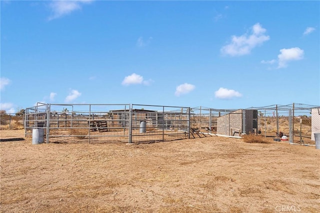 view of yard featuring a rural view and an outdoor structure