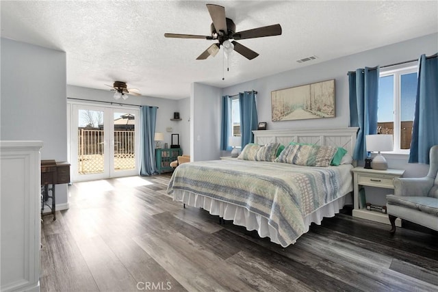 bedroom with french doors, a textured ceiling, hardwood / wood-style flooring, ceiling fan, and access to exterior