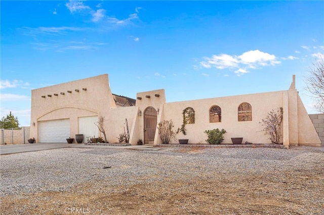 pueblo-style house with a garage