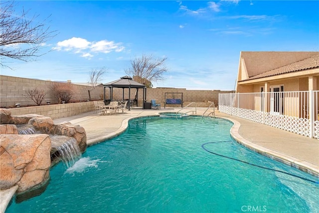 view of swimming pool with a patio, a gazebo, and pool water feature