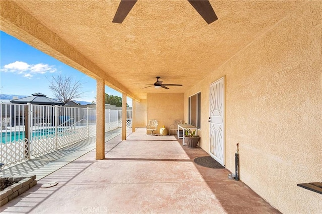 view of patio with a fenced in pool and ceiling fan