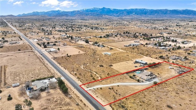 birds eye view of property with a mountain view