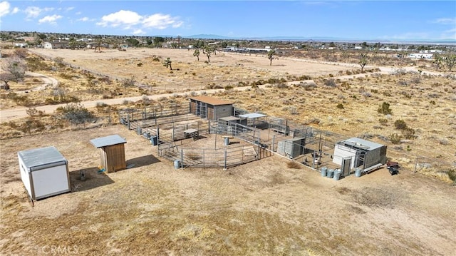 birds eye view of property with a rural view