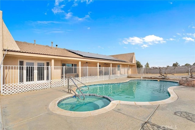 view of swimming pool featuring an in ground hot tub and a patio