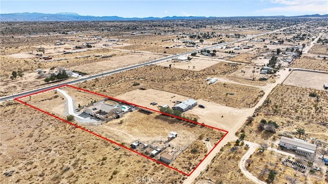 birds eye view of property with a mountain view