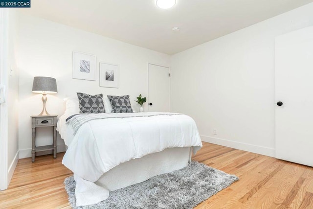 bedroom with hardwood / wood-style flooring