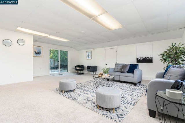 living room featuring a paneled ceiling and light colored carpet