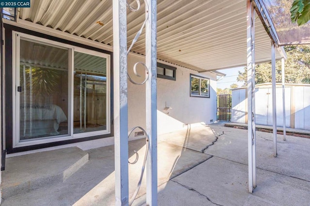 view of patio featuring a storage shed