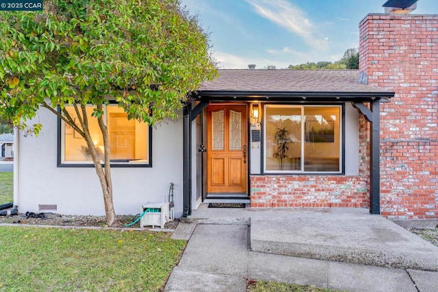 property entrance with a yard