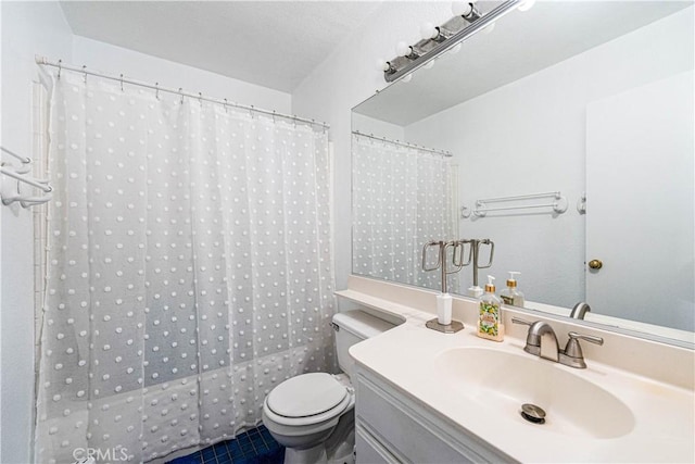 bathroom with vanity, toilet, and a shower