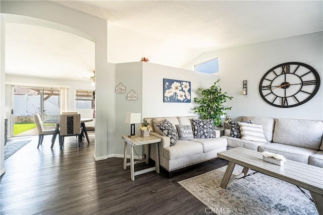 living room with dark hardwood / wood-style flooring and lofted ceiling