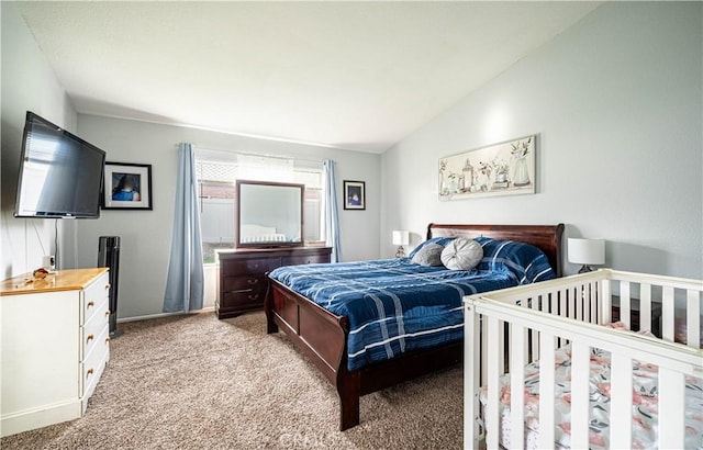 bedroom with lofted ceiling and light carpet