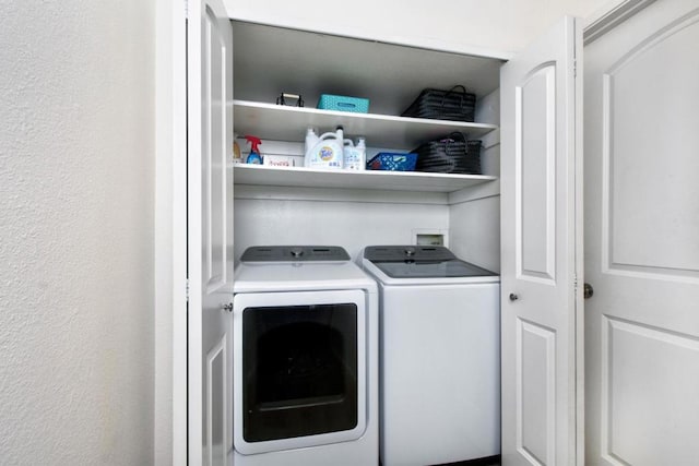 washroom featuring washer and clothes dryer