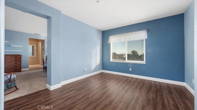 spare room featuring dark hardwood / wood-style flooring