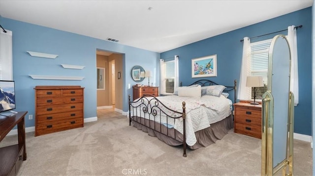 bedroom featuring light carpet