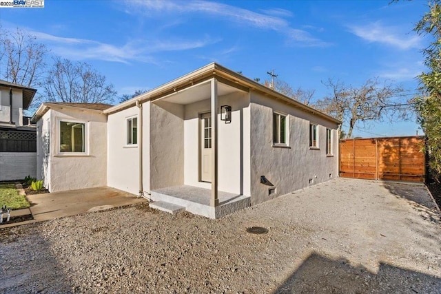 back of house with a patio