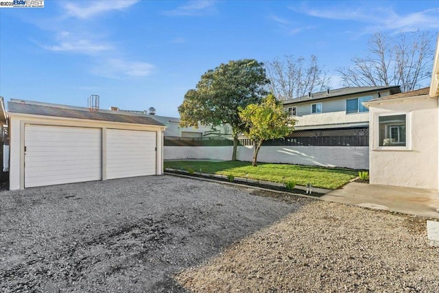 exterior space with a garage and an outdoor structure