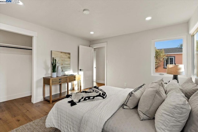 bedroom featuring hardwood / wood-style floors and a closet