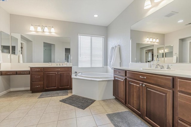 bathroom featuring tile patterned flooring, vanity, and a washtub