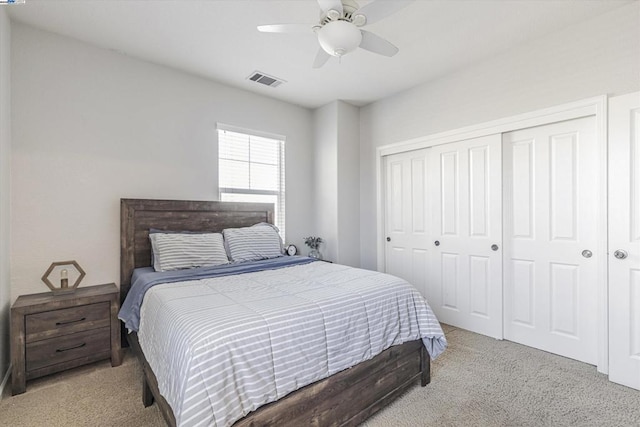 bedroom with light carpet, a closet, and ceiling fan