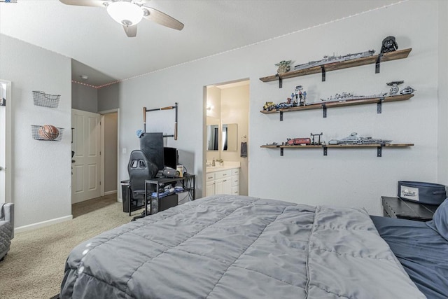 bedroom featuring ceiling fan, light colored carpet, connected bathroom, and sink