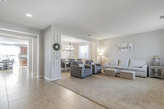 living room featuring a chandelier and light tile patterned floors