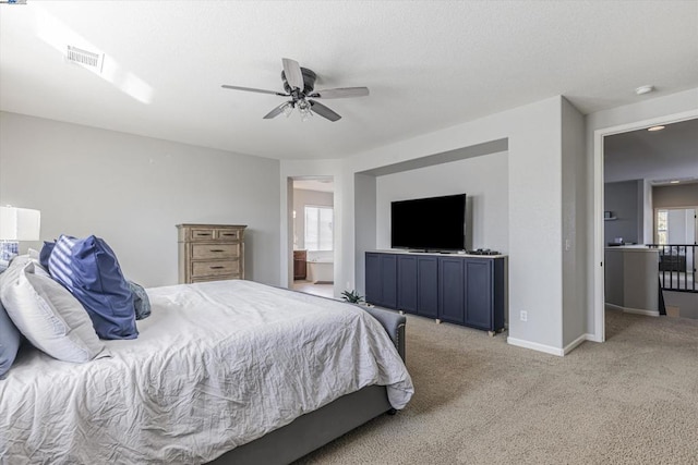 carpeted bedroom featuring ceiling fan and connected bathroom