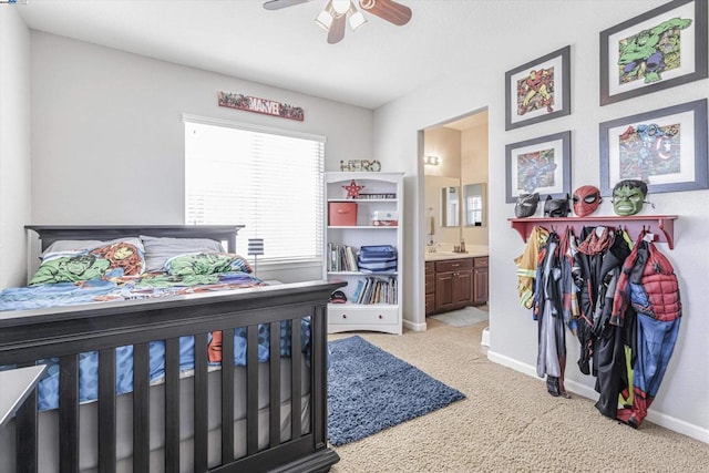 carpeted bedroom featuring connected bathroom and ceiling fan