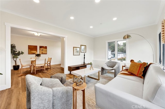 living room with ornamental molding and light wood-type flooring