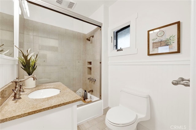 full bathroom with tiled shower / bath combo, vanity, tile patterned floors, and toilet