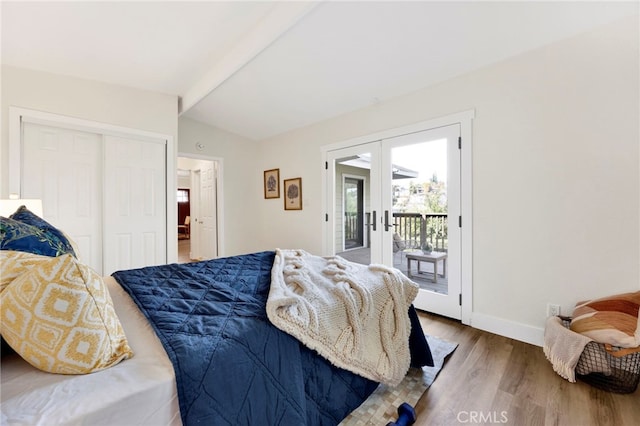 bedroom with french doors, lofted ceiling with beams, access to outside, a closet, and hardwood / wood-style floors