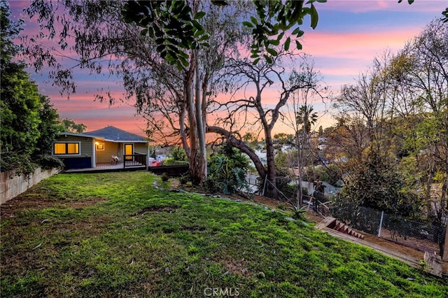 yard at dusk with a wooden deck