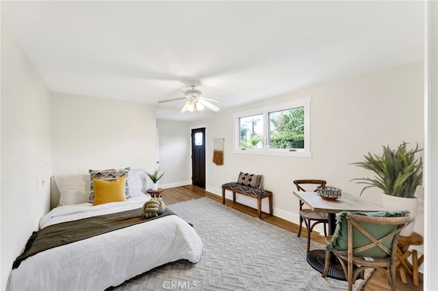 bedroom with ceiling fan and light wood-type flooring