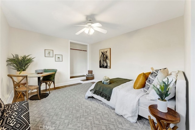 bedroom with ceiling fan and light wood-type flooring