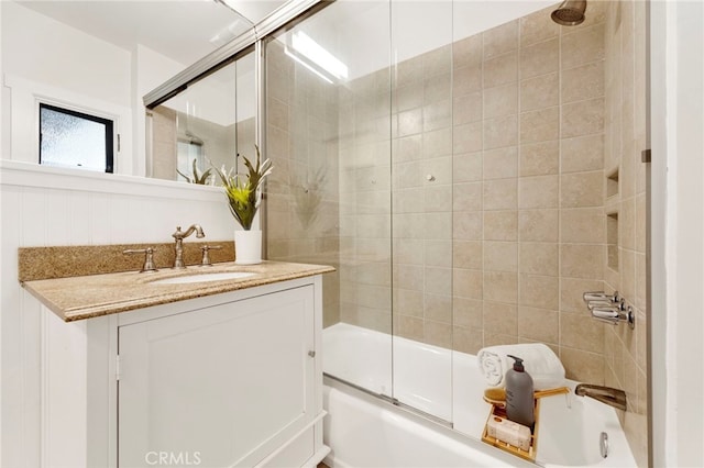 bathroom with vanity and shower / bath combination with glass door