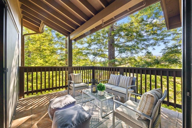 wooden terrace with an outdoor living space