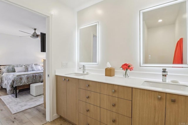 bathroom featuring ceiling fan, vanity, and wood-type flooring