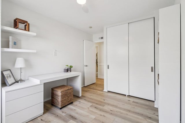 office featuring light hardwood / wood-style floors and ceiling fan