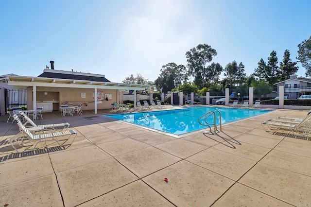 view of swimming pool with a patio area